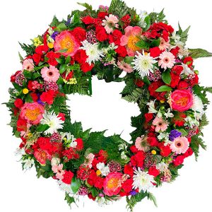Corona de flores en tonos rojizos con flor de temporada